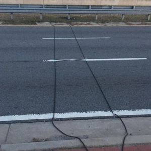 Here’s what those mysterious black cables on the road signify.