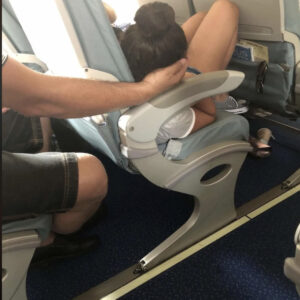 Dad sparks online debate after cradling daughter’s head for 45 minutes so she could sleep during a flight