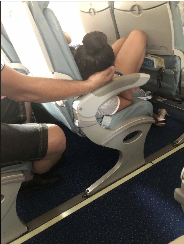 Dad sparks online debate after cradling daughter’s head for 45 minutes so she could sleep during a flight