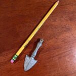 I found an old, finger-sized thing in an old house; does anyone know what it might be? Almost looks like a tiny shovel.