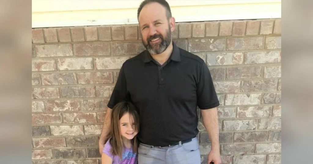 As the father rushes to pick up his 6-year-old daughter from school, the teacher quickly notices a detail on his pants.
